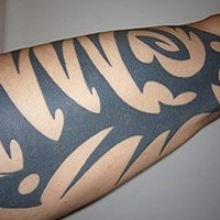 Black arm tattoo in tribal style