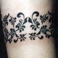 Black ink floral bracelet tattoo