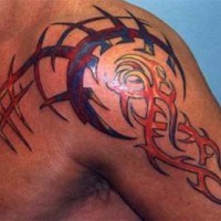 Colored tribal tattoo on chest and shoulder
