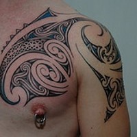 Pretty cool tribal tattoo on chest and shoulder