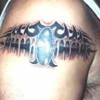 Shoulder tattoo of black tribal armlet