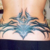 Big and black tribal tattoo on lower back