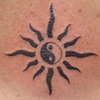Tribal yin yang tattoo with black sun