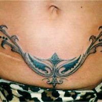 Tribal curved tattoo on lower belly