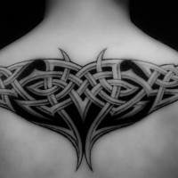 Black tattoo braided pattern  on upper back