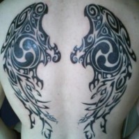 Black tribal wings tattoo on back