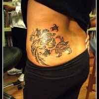 Big black turtle tattoo on lower back