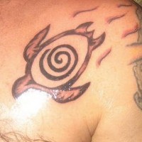 Chest tattoo of turtle with swirl on shell