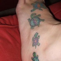 Dancing colored turtles tattoo on foot