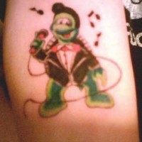 Turtle singer in black suit on tattoo