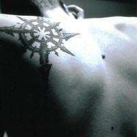 Navigator on upper back tattoo with many arrows