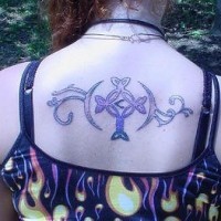Decorated tattoo rounded cross on upper back