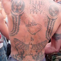 On upper back crowned heart and fireing bird tattoo