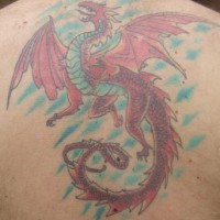Shouting dragon on upper back red tattoo