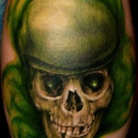 Leg tattoo, green styled, awful skull, teethy