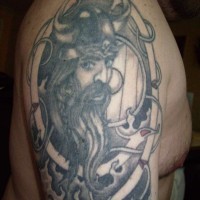 Shoulder tattoo with young viking in helmet