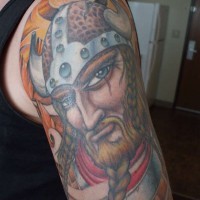 Colorful tattoo of viking with beard braid in a braid