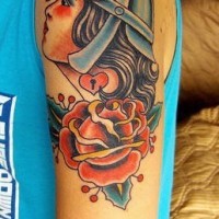 Shoulder tattoo of girl in helmet with big rose