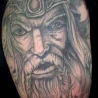 Serious viking warrior with braids on mustache tattoo