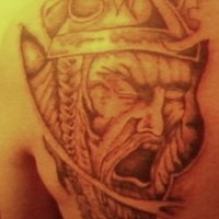 Shouting viking warrior in helmet tattoo on scapula