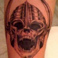 Viking tattoo of angry skull in helmet