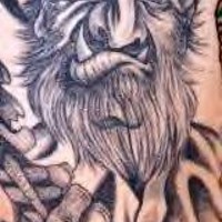 Viking tattoo of warrior with horns and big teeth