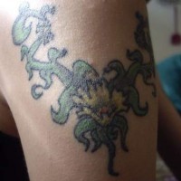 Colored shoulder tattoo of vine with flower
