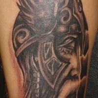 Sad warrior with long beard in helmet with wings tattoo