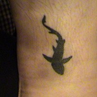 Water animal tattoo with all black floating shark