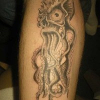 Scary octopus with big eyes tattoo on leg
