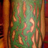 Big leg tattoo with green jellyfish