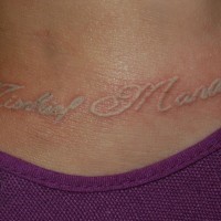 Tatuaje con la inscripción en tinta blanca en el tobillo