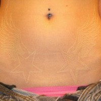 White ink wings tattoo on belly