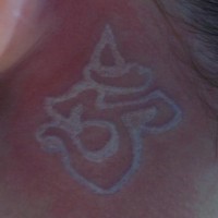 White ink tattoo with yoga sign om