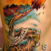 Colorful tree tattoo with ribbon with the inscription