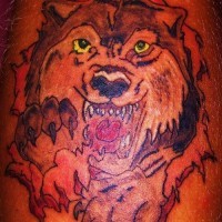 Red angry wolf with yellow eyes tattoo