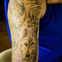 Big tattoo on hand with wolf and indian man