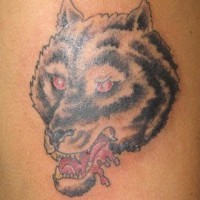 Angry black wolf with red eyes tattoo