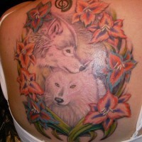 Back tattoo with wolves and flowers