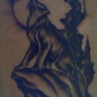 Tattoo with howling wolf on the rock