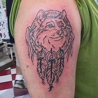 Nice wolf tattoo with feathers on the shoulder