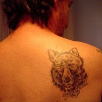 Wolf head tattoo on scapula