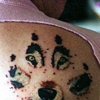 Tattoo with wolf step and eyes & mouth on it