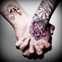 Skull and rose tattoo on both hands