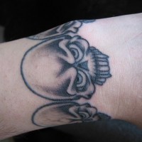 Big skulls and biohazard wrist tattoo outward