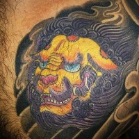 Yellow asian lion chest tattoo