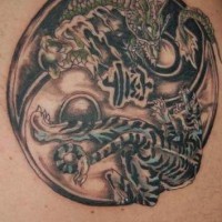 Black yin yang tattoo with dragon and tiger