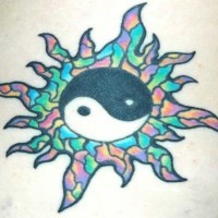 Yin yang tattoo decorated with colored glass