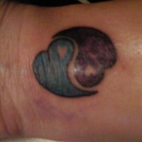 Yin and yang tattoo with hearts
