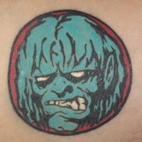 Small zombie face tattoo